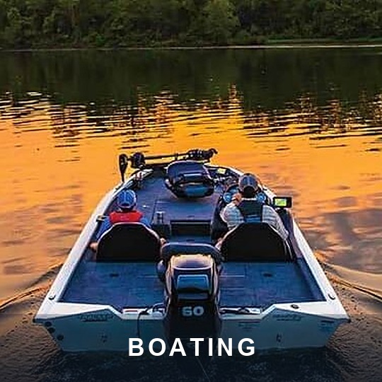 Bass boat with two anglers running across a calm lake at sunset, caption BOATING