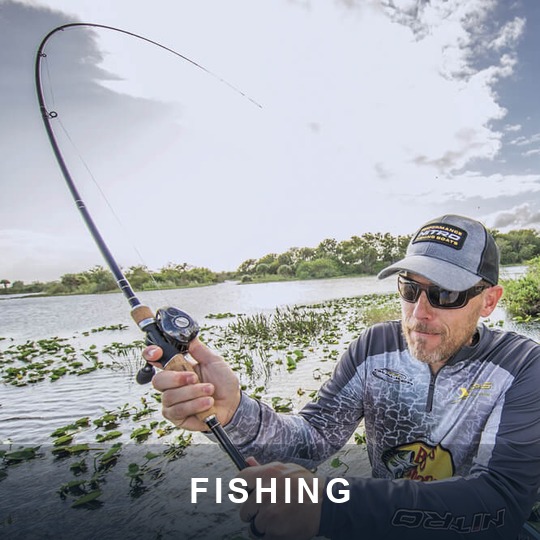 Angler in a bass boat fighting a fish with a baitcasting rod on a weedy lake, caption FISHING